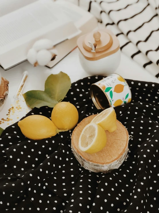 a small cup and some lemons on a table