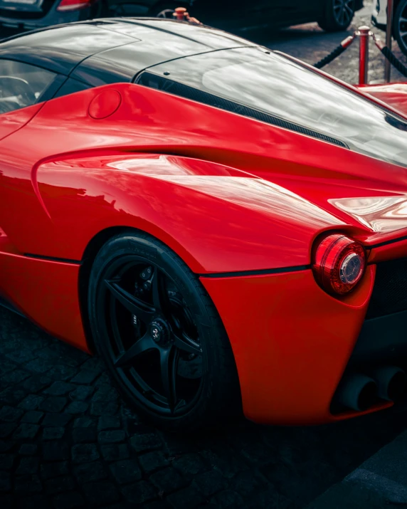 a red sports car sitting next to other cars