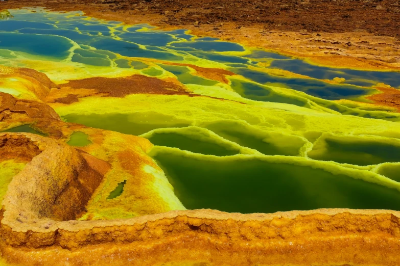 some colored sand water rocks and dirt