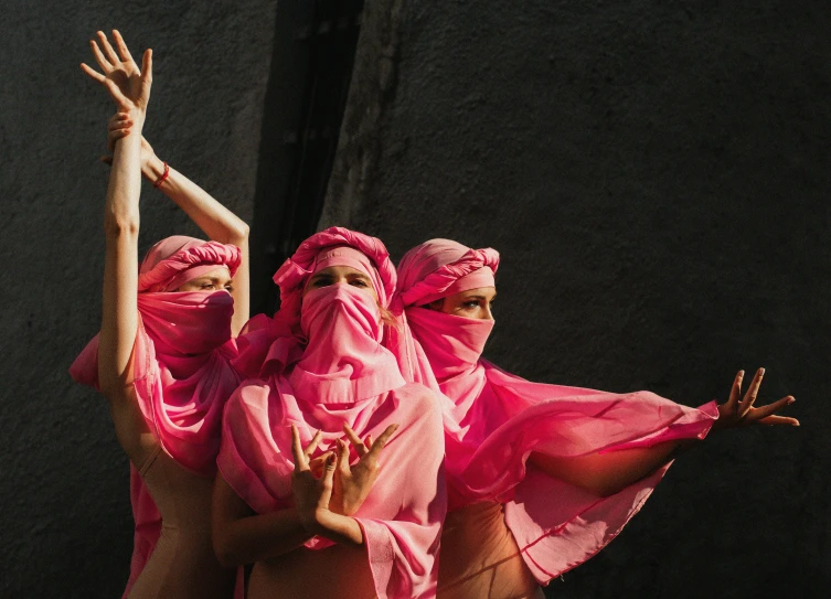 two women in pink are performing somersace