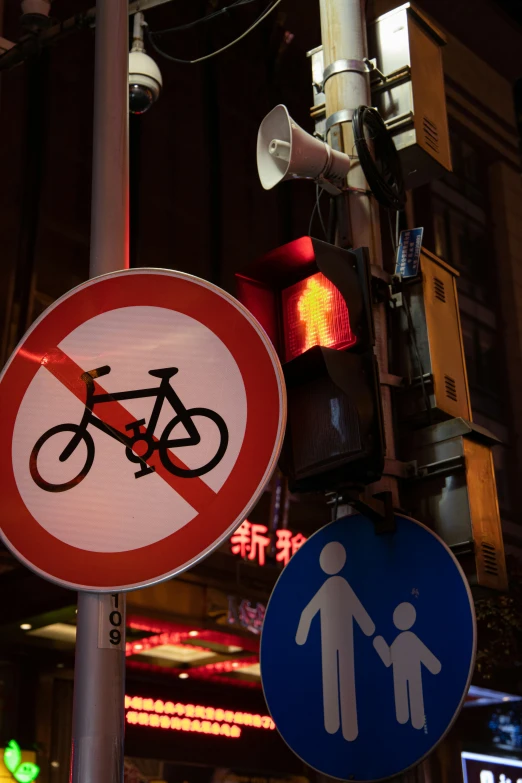 a pole with various signs including a cross walk and no pedestrian crossing sign