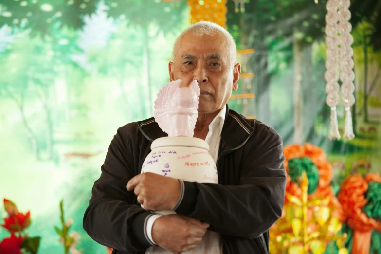 an old man holding up a baby bottle