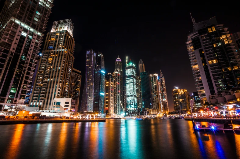 a skyline with multiple skyscrs lit up at night