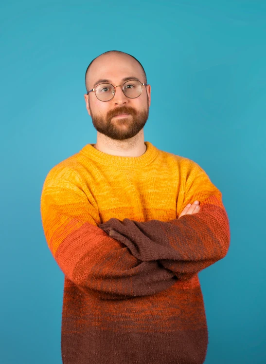 a man wearing a yellow and brown sweater