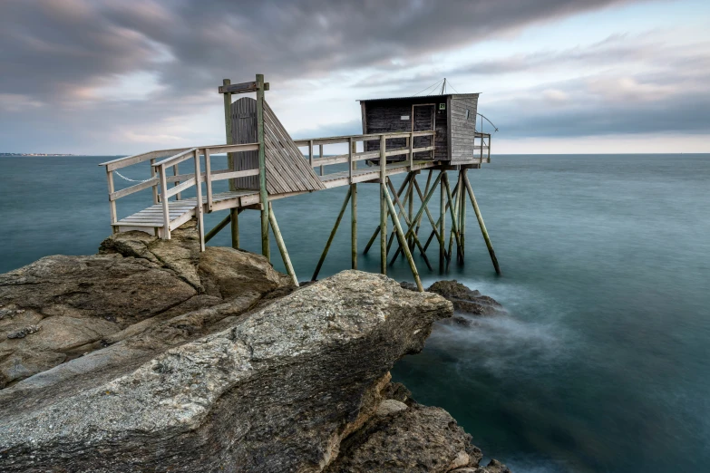 a wooden pier sticking out into the ocean