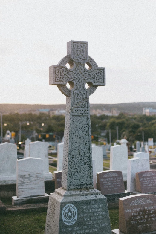 the stone cross is in a graveyard