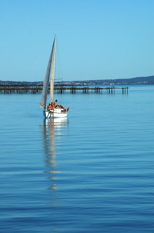 a boat with people sailing in the open water