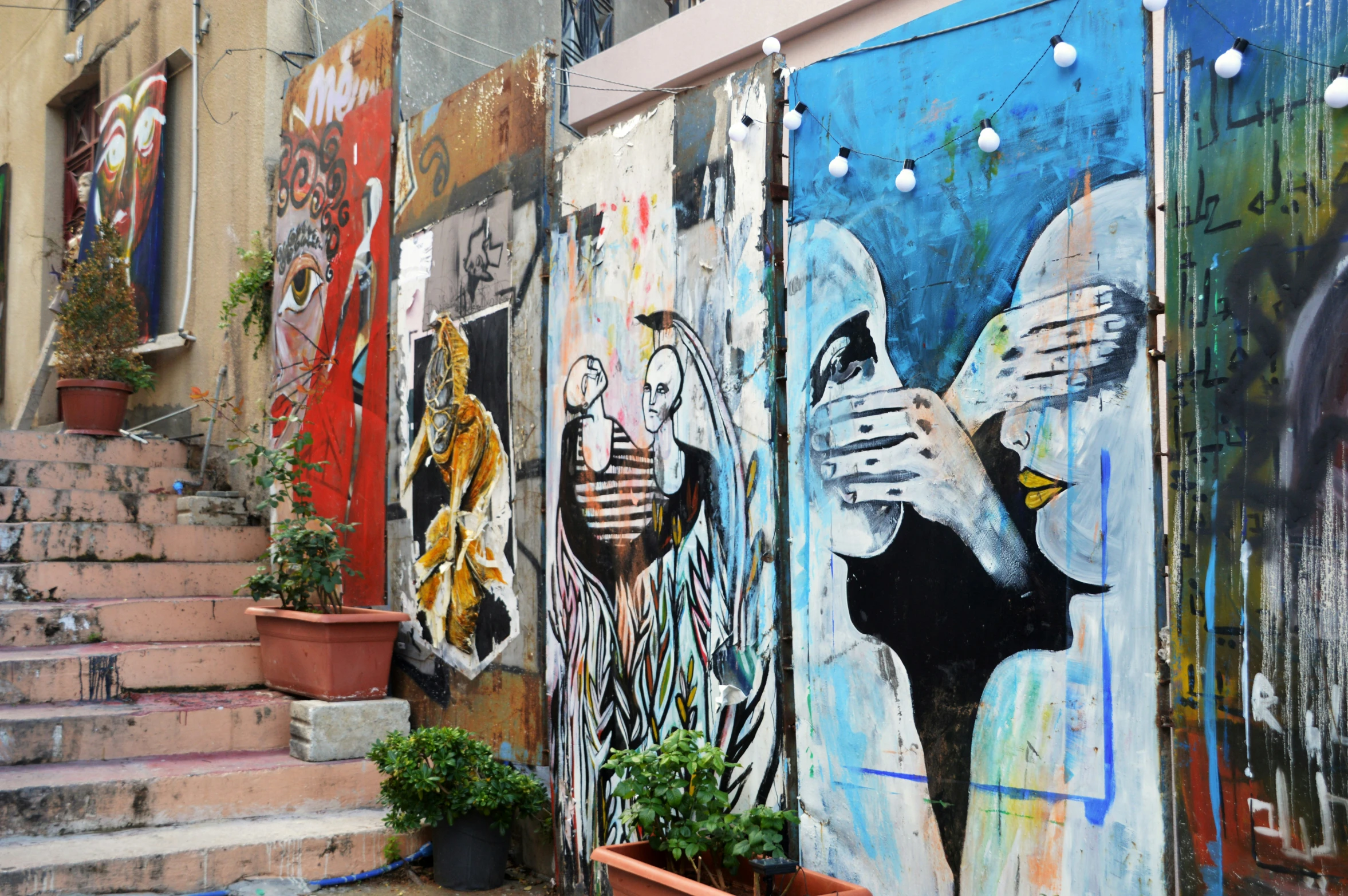 graffiti on a city building wall by stairs