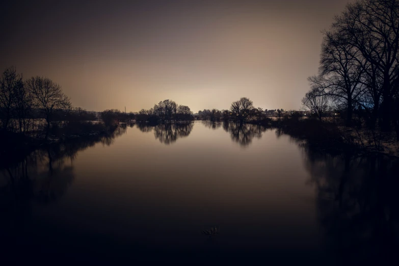 a foggy night with a lake and trees