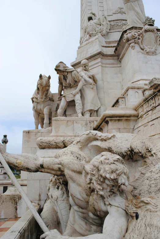 statues of men and horses with stairs leading up them