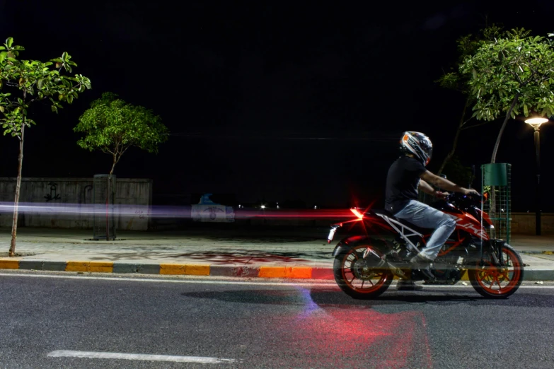 a person wearing a helmet is on a red motorcycle