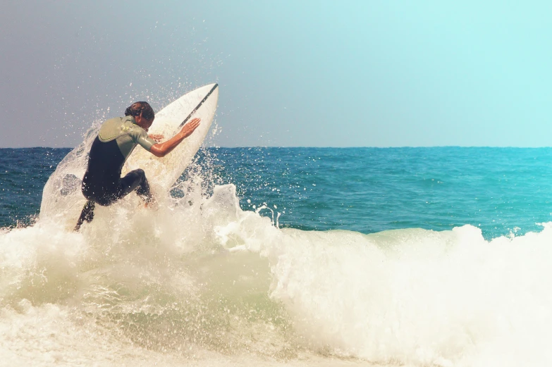a man holding a surfboard while surfing in the ocean