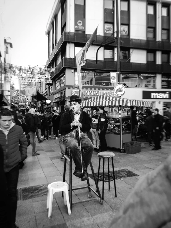 the man is sitting down on the chair with his arms crossed