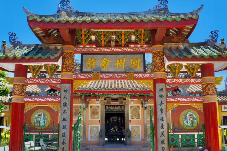 a red and yellow temple in a large asian city