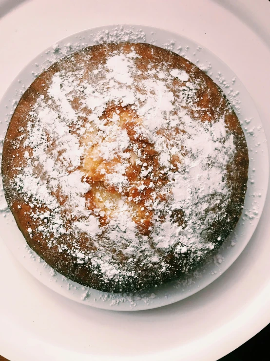 a round cake sitting on top of a white plate