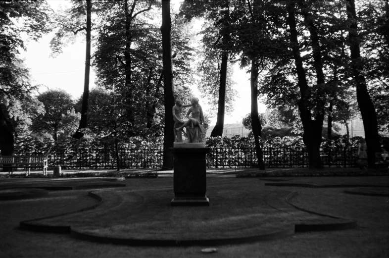 black and white pograph of statues and trees