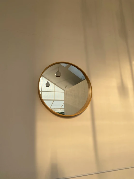 a large round mirror hanging on a wall