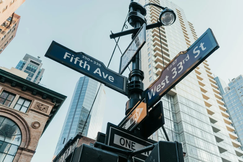 signs and lights in a city on a pole