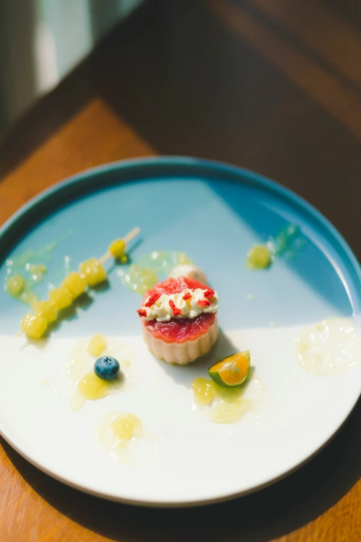 dessert on plate sitting on wooden table with green and yellow jello