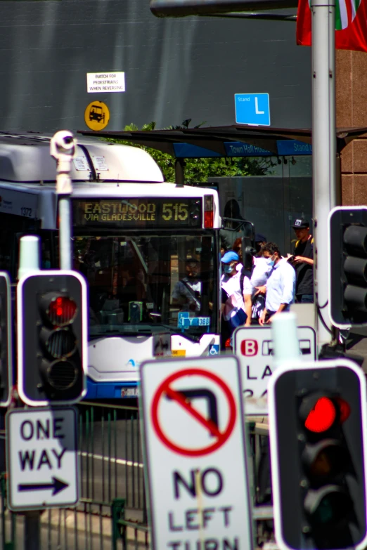 a bunch of traffic signs outside with one light and several others in the background