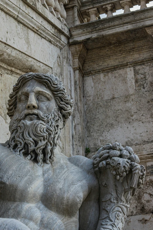 a statue of a greek god in a temple