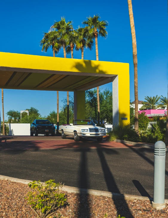 two vehicles are parked at a gas station