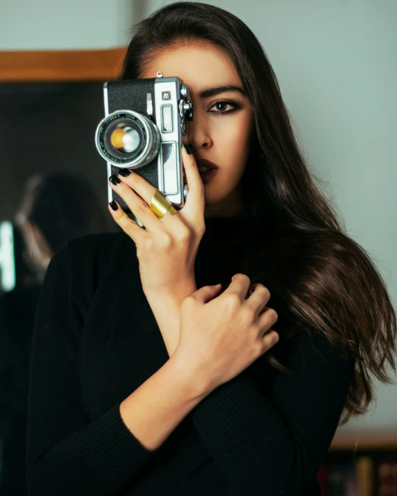 a woman is taking a picture with a camera