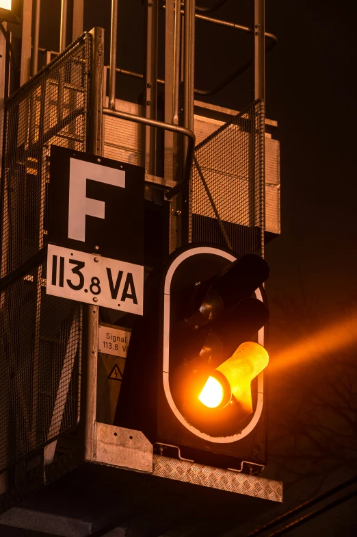 a traffic signal with yellow light near building