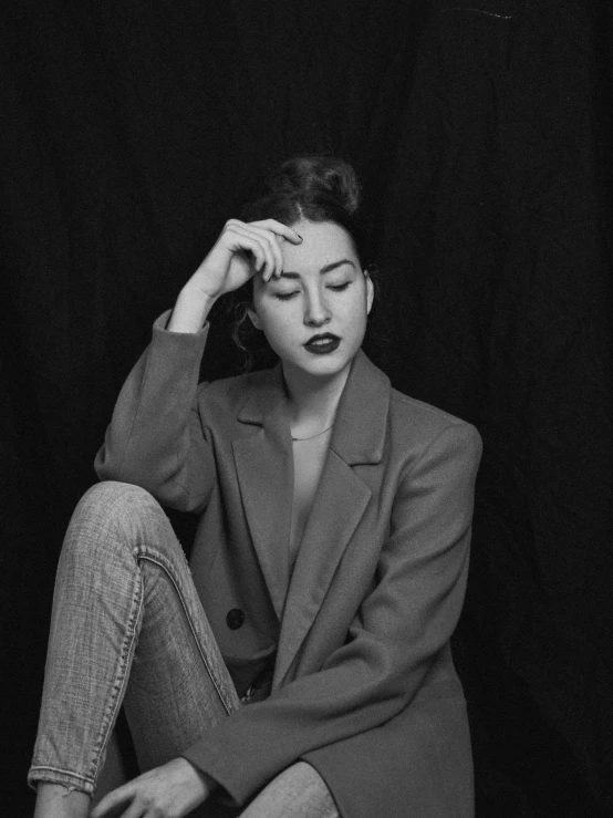 a black and white po of a woman sitting down