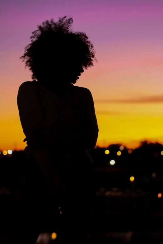 a girl in the dark with her hands on her chest