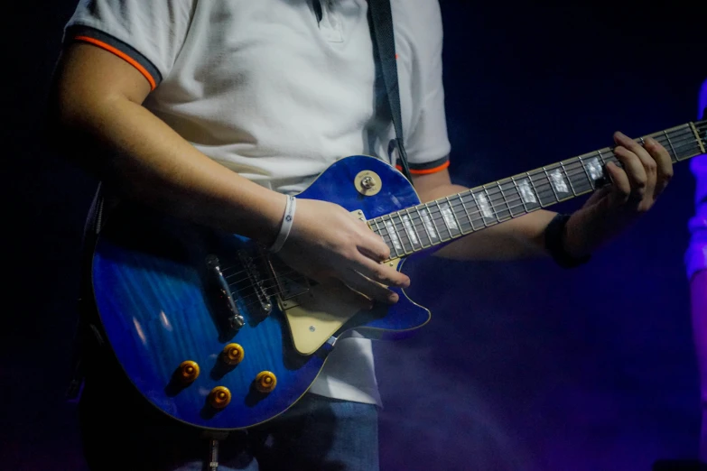 a person playing with an electric guitar