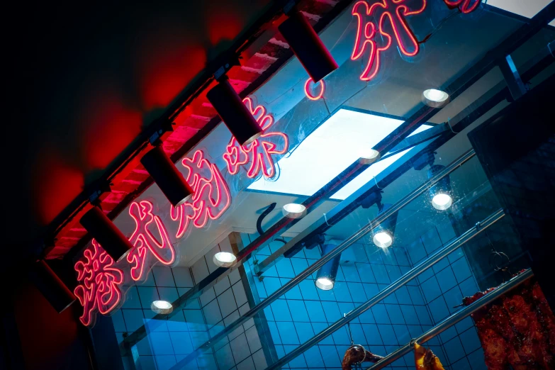 a storefront lit up with neon signs