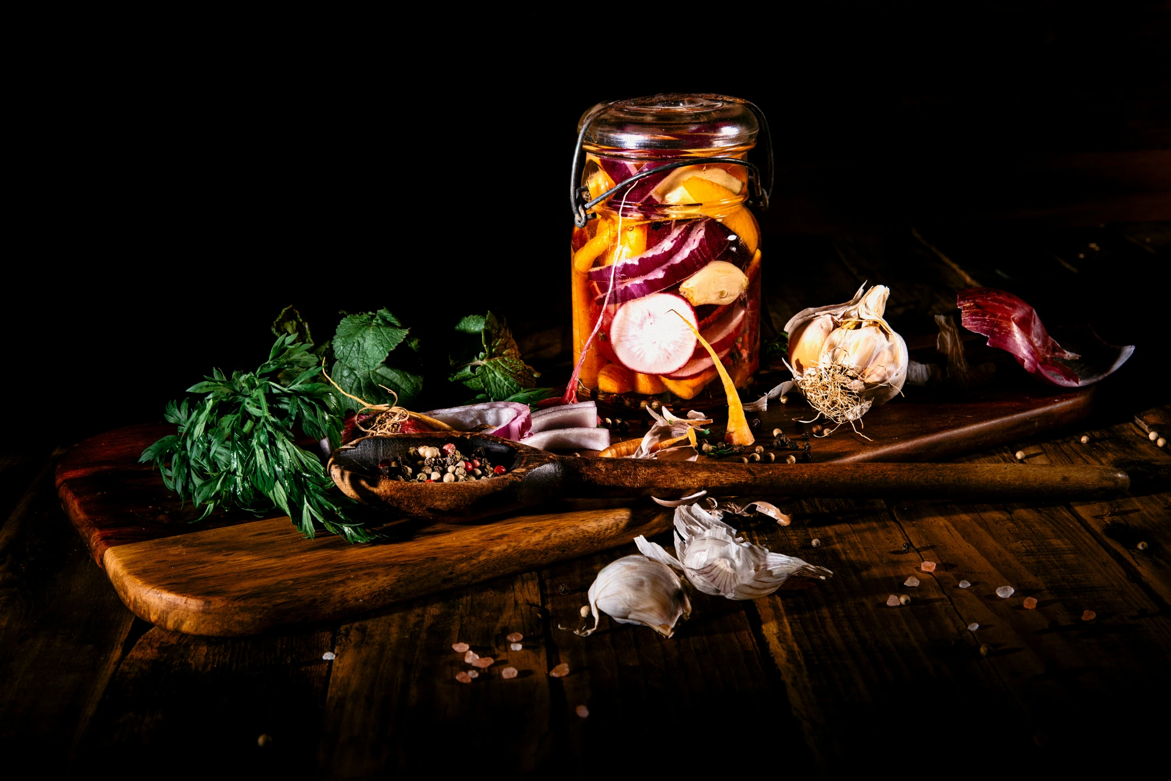 various veggies are displayed next to an empty mason jar