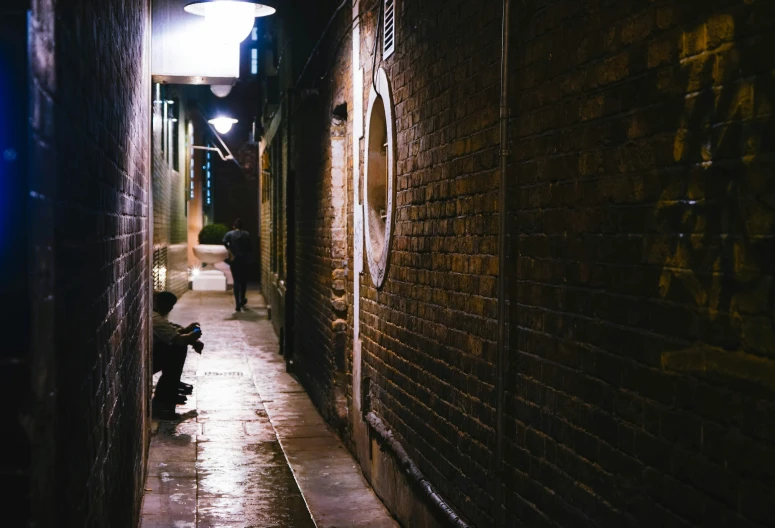 a person is riding a skateboard down a narrow alley