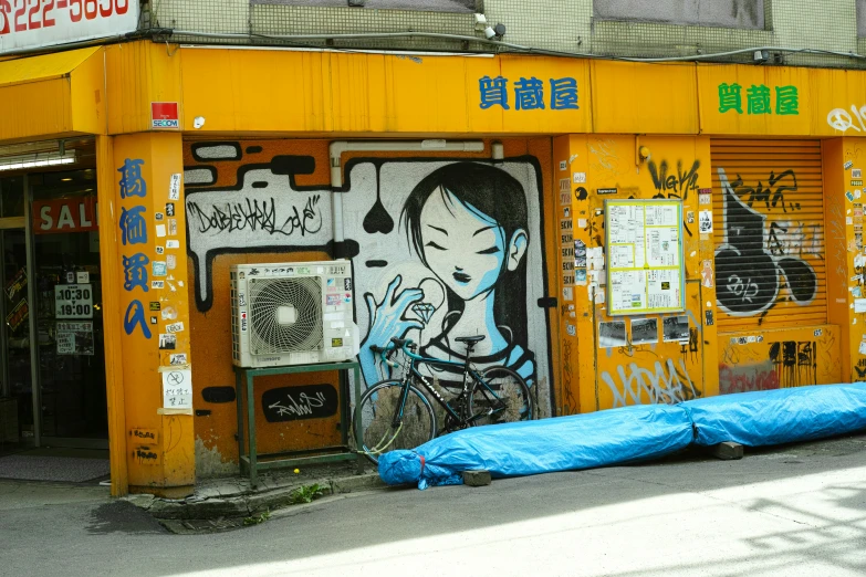 an orange store with asian graffiti on the doors