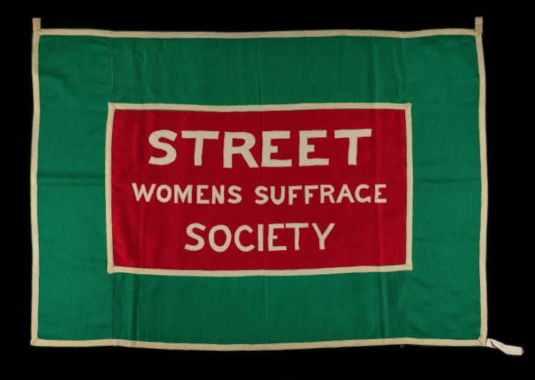 a green blanket with a red sign reading street women's surfaces society