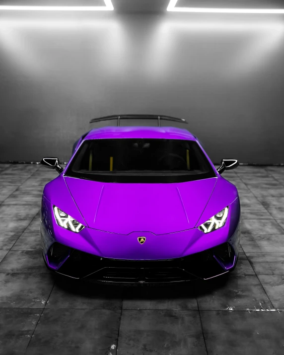 a purple car is shown in the spotlight