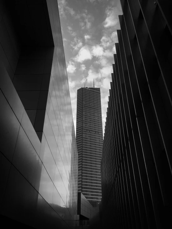 buildings are silhouetted against a cloudy sky on a sunny day