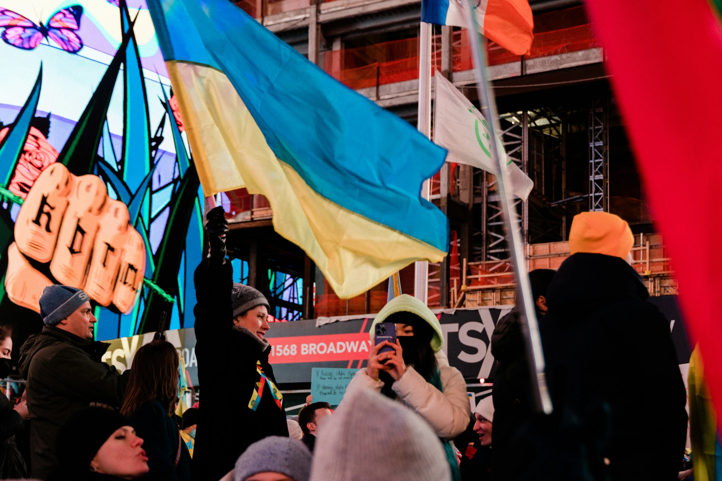 a crowd of people that are standing in front of signs