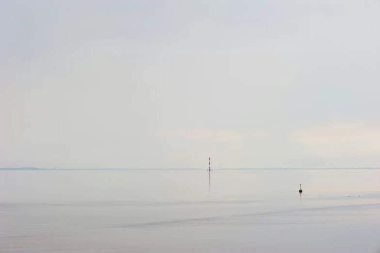 the person is walking through shallow water alone