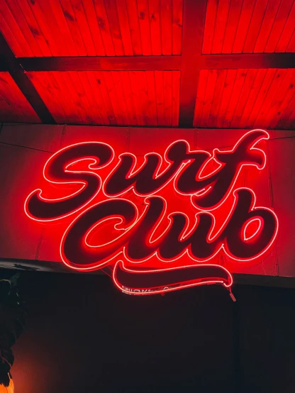 an illuminated sign for the street club