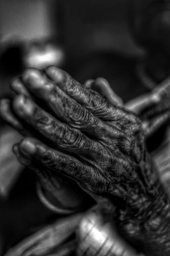 closeup po of an adult's hands with skin, nails and nails, while the image is in black and white