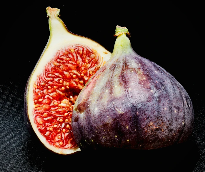 a sliced up fig with seeds in front of it