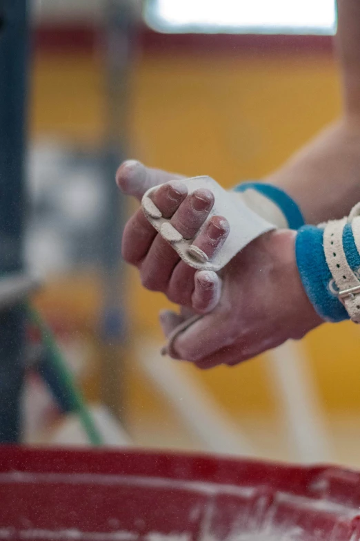 a person's hand wearing sports gloves and wristbands