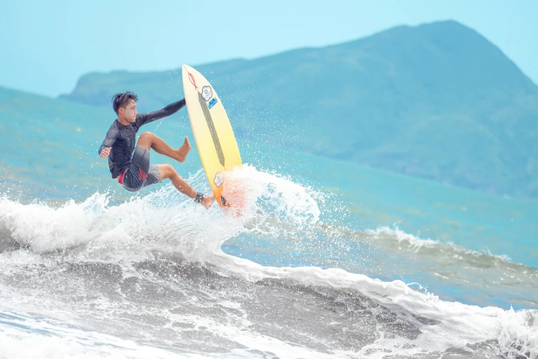 a man is surfing on a small wave in the ocean