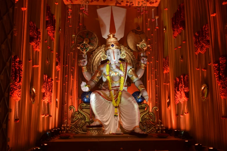 a statue of the god ganpati with glowing colors