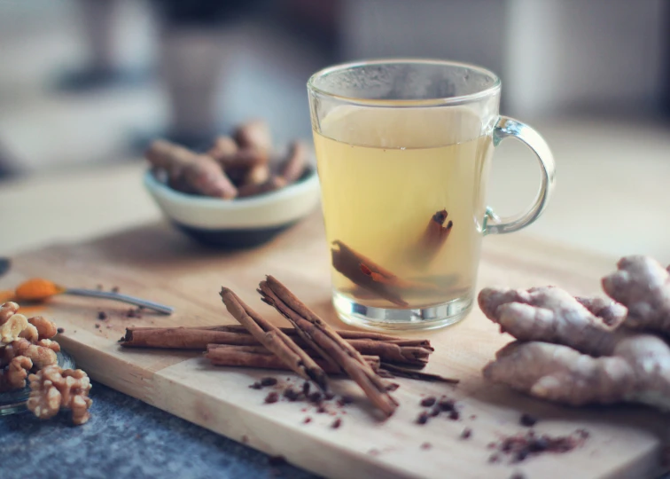 there is an object on a board next to a cup of tea