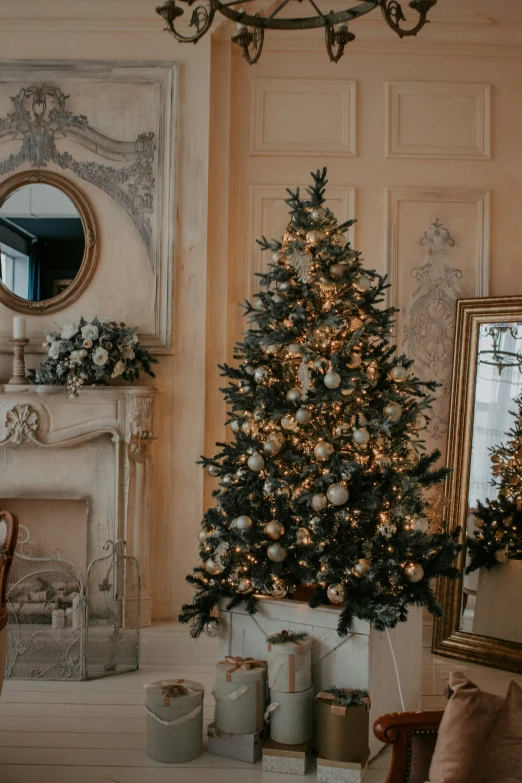 a small christmas tree and presents near a mirror