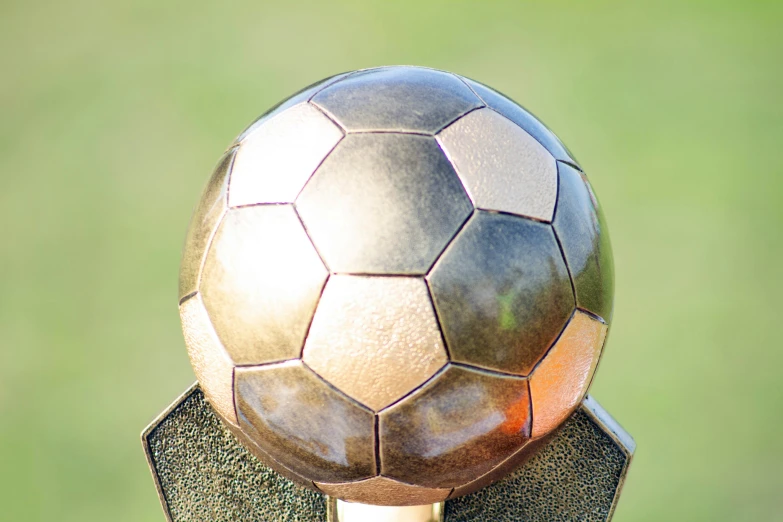 a shiny soccer ball sitting on top of a table