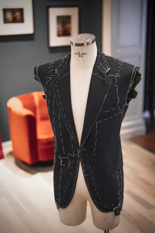a mannequin's body in a black suit vest is shown